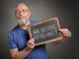 What questions do you have. Text on a blackboard. photo