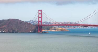 Golden Gate Bridge with Sailboat and Marin County Hills in View photo
