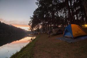 Camping tent on green grass field photo