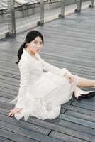 Asian Girl Wearing White Suit at The Shoppes Marina Bay Sands Rooftop Singapore photo