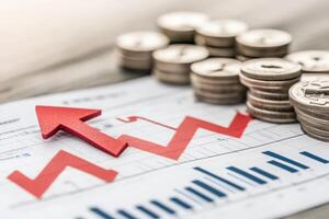 A vivid red downward arrow pierces through a stack of coins, symbolizing a sudden decline on a financial report, highlighting market instability and economic downturn. photo