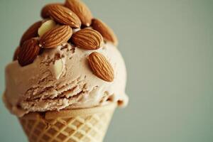 A tempting ice cream cone features a smooth chocolate-flavored scoop adorned with whole almonds. It offers a delightful treat perfect for warm days, showcasing a creamy texture and nutty crunch. photo