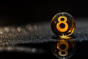 A singular snooker ball sits alone, glistening with a droplet on its surface amidst a softly lit, moody background. The focus highlights its vibrant color and the number displayed. photo