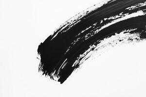 A dynamic display of bold black brush strokes sprawls across a pristine white surface. The contrasting colors create a striking visual effect, emphasizing artistic expression and creativity. photo