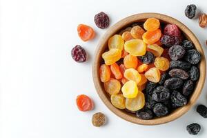 A wooden bowl filled with a colorful assortment of dried fruits sits neatly on a clean surface. The vibrant mix includes raisins and apricots, perfect for healthy snacking. photo