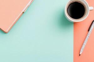 A neat workspace featuring a cup of black coffee, an open notebook, and a pen on a solid pastel surface. This setup inspires a productive return to work. photo