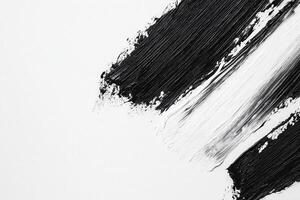 Dynamic black brush strokes contrast sharply with a pristine white background, showcasing an abstract artwork that emphasizes texture and movement in a minimalist style. photo