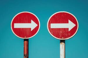 Two red and white border crossing signs point right on a bright blue day, providing clear directional guidance for travelers at a defined location, emphasizing navigation and safety. photo
