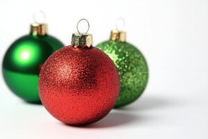 Bright Christmas tree ornaments in vibrant red and green glimmer with festive sparkles, creating a cheerful holiday atmosphere on a pristine white backdrop, perfect for holiday decorating. photo