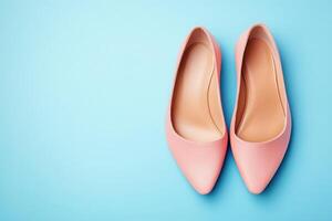 A pair of chic ballet flats rests on a vibrant blue surface, showcasing a modern design ideal for fashionable outfits. The soft pink color adds elegance and versatility for any occasion. photo