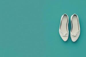 These chic ballet flats are showcased against a solid turquoise background, emphasizing their elegant design and perfect fit for casual or semi-formal occasions. photo