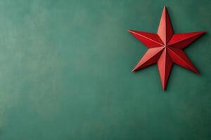 A vibrant red star is placed against a smooth green backdrop, embodying the spirit of Christmas and adding festive charm to the setting. This decoration highlights holiday joy beautifully. photo