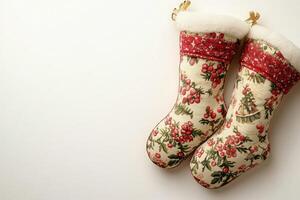 These festive Christmas stockings are adorned with vibrant patterns, positioned neatly on a clean, solid background, adding a joyful touch to the holiday season. photo