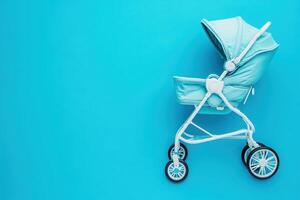 A compact baby buggy stands out on a solid blue background, showcasing its sleek design and practical features. photo