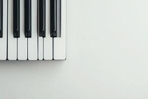 The grand piano keys are displayed cleanly against a solid light background, showcasing the contrast between the black and white keys. This composition emphasizes musical elegance and simplicity. photo