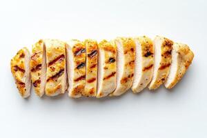 Tender grilled chicken slices are isolated in the center, displaying their appetizing char marks. The arrangement highlights the juicy and flavorful texture of the meat, ideal for meal preparation. photo