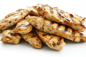 Tender grilled chicken slices are presented in the center, showcasing their golden-brown grill marks and juicy texture, making for a perfect addition to salads, sandwiches, or wraps. photo