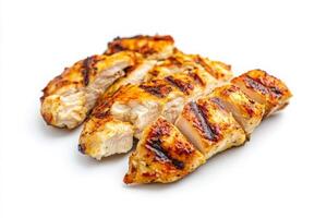 Juicy grilled chicken slices are neatly arranged in the center against a white backdrop, showcasing their golden-brown grill marks and tender texture, perfect for a healthy meal or recipe. photo