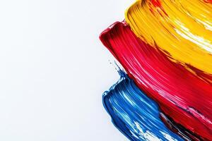 Bold strokes of red, yellow, and blue form dynamic lines against a pristine white backdrop, showcasing a striking contrast and vibrant energy in the composition. photo