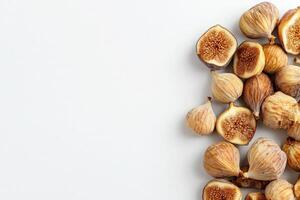 A collection of dried figs is artistically laid out on a smooth, solid white background, showcasing their unique shapes and textures, highlighting their natural, sweet appeal for snacks and recipes. photo
