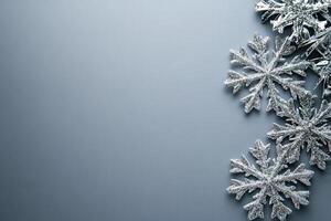 The composition features elegant decorative snowflakes resting on a pristine gray background, creating a winter-inspired atmosphere perfect for holiday decor or seasonal crafts. photo