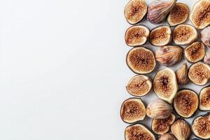 Dried figs are thoughtfully arranged on a clean white background, highlighting their unique shape and rich, natural sweetness. These nutritious fruits are perfect for snacking or culinary uses. photo