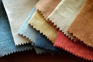 A collection of fabric swatches featuring solid colors and a clean, minimalist design is spread across a flat surface. The swatches vary in texture and hue, creating a harmonious visual appeal. photo