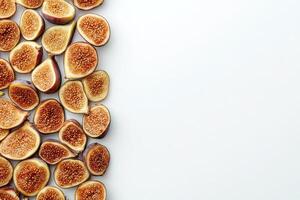 An assortment of dried figs is neatly laid out against a pristine white backdrop, highlighting their rich colors and textures. photo