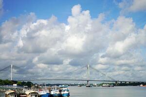 Ship tied at Kolkata Ganga Ghat, Vidyasagar Setu in background photo