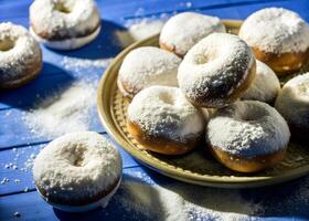 Overhead view of perfectly round wheat donuts, with powdered sugar falling like snow, creating a dramatic, inviting mood photo