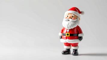 A toy santa claus figurine standing on a white background photo