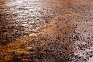 Many rugged holes on the rusty color concrete floor photo