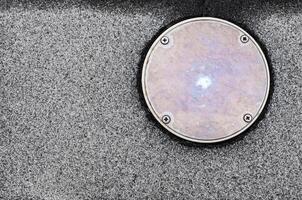 The surface texture on the non slip flooring and the metal cover of service hole beside the pool photo