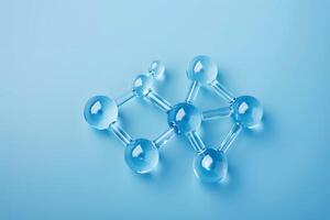 Transparent molecular structure with connected spheres isolated on a light blue background. Concepts of cosmetology, science and chemistry photo