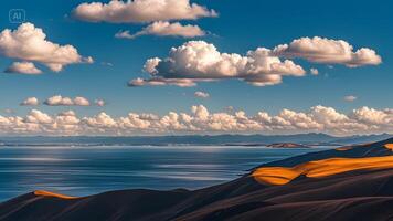 A beautiful view of the ocean and clouds over a sand dune photo