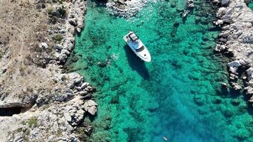 Drone View of Island Surrounded by Moored Yachts in Vibrant Turquoise Waters video