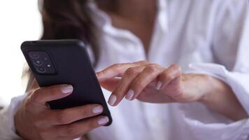 young woman looking and touching smart mobile phone. touching smart mobile phone reading social network woman messaging to internet online, communication concept. video