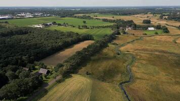 Aerial view of a farm and fields with a river video