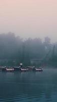 A boat is floating on the water in the fog video
