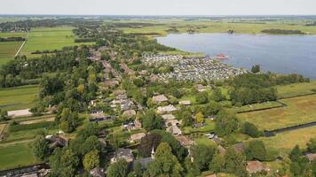 Aerial view of a village with a lake and a river video