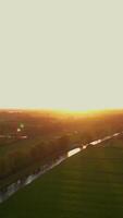 A river running through a field at sunset video