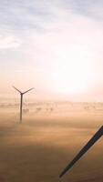Wind turbines in the fog at sunrise video