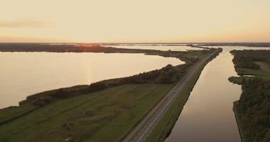 Aerial view of a road and a river at sunset video