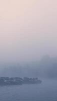 A boat is in the water with fog in the background video