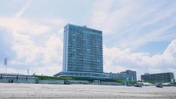 A large building on the beach next to a building video