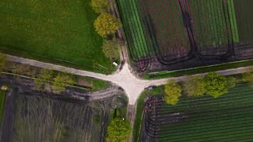 Aerial view of a road intersection in the middle of a field video