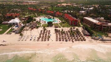 Aerial view of resort beach with coconut trees and turquoise ocean on island video