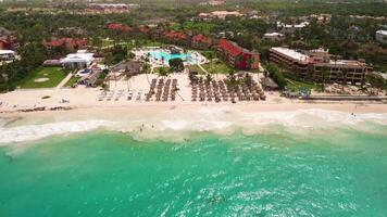 Aerial view of resort beach with coconut trees and turquoise ocean on island video
