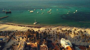 Aerial view of the Bavaro resort with a public white sand beach.Turquoise waters of the Caribbean Sea, a tropical paradise in the rays of the setting sun, Punta Cana, Dominican Republic.Boat trips video