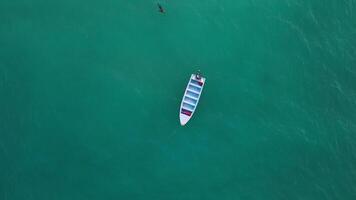 Aerial top view of a man sailing to a boat in the Caribbean coast of the Dominican Republic. The concept of tourism, recreation, the power of nature and travel. video